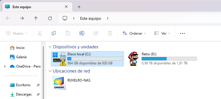 Captura del Explorador de Archivos de Windows mostrando la unidad C: con un icono de candado y un triángulo amarillo de advertencia de BitLocker.
