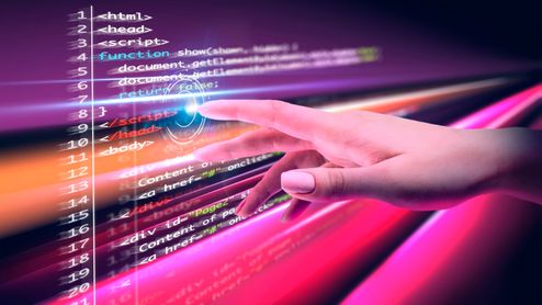 Mano interactuando con líneas de código de programación en una interfaz digital con luces de colores neón.
