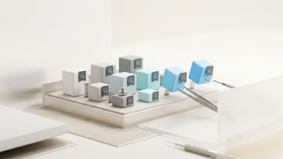 Representación artística de cubos con iconos de hojas siendo manipulados por pinzas en una plataforma limpia.