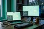 Entorno de escritorio de la distribución Linux Mint ejecutándose en un ordenador portátil y un monitor externo sobre una mesa de madera.
