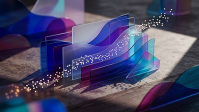 Composición artística de paneles de cristal translúcido en tonos azules y púrpuras con partículas de luz sobre una superficie texturizada.